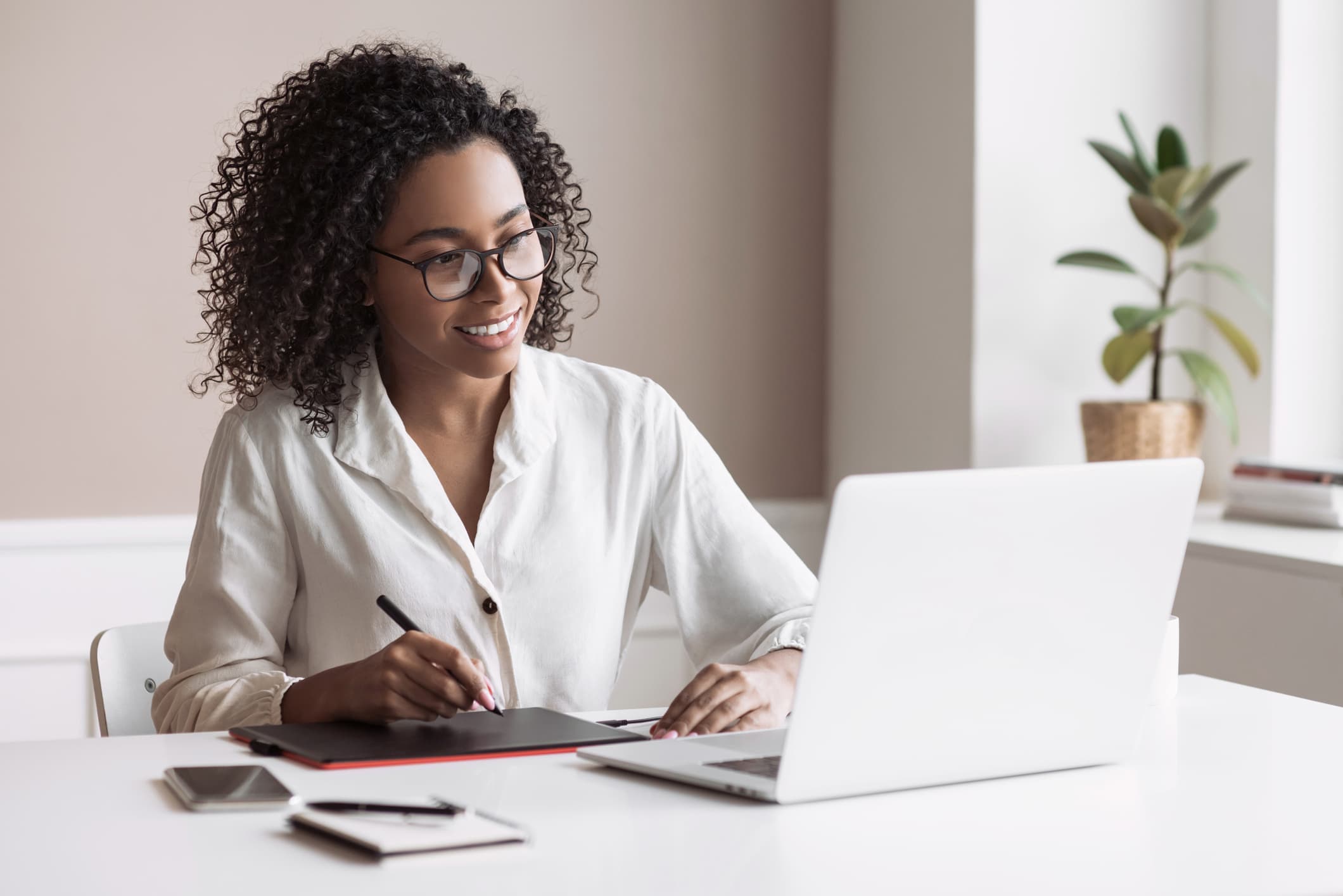 Woman sitting at desk using computer